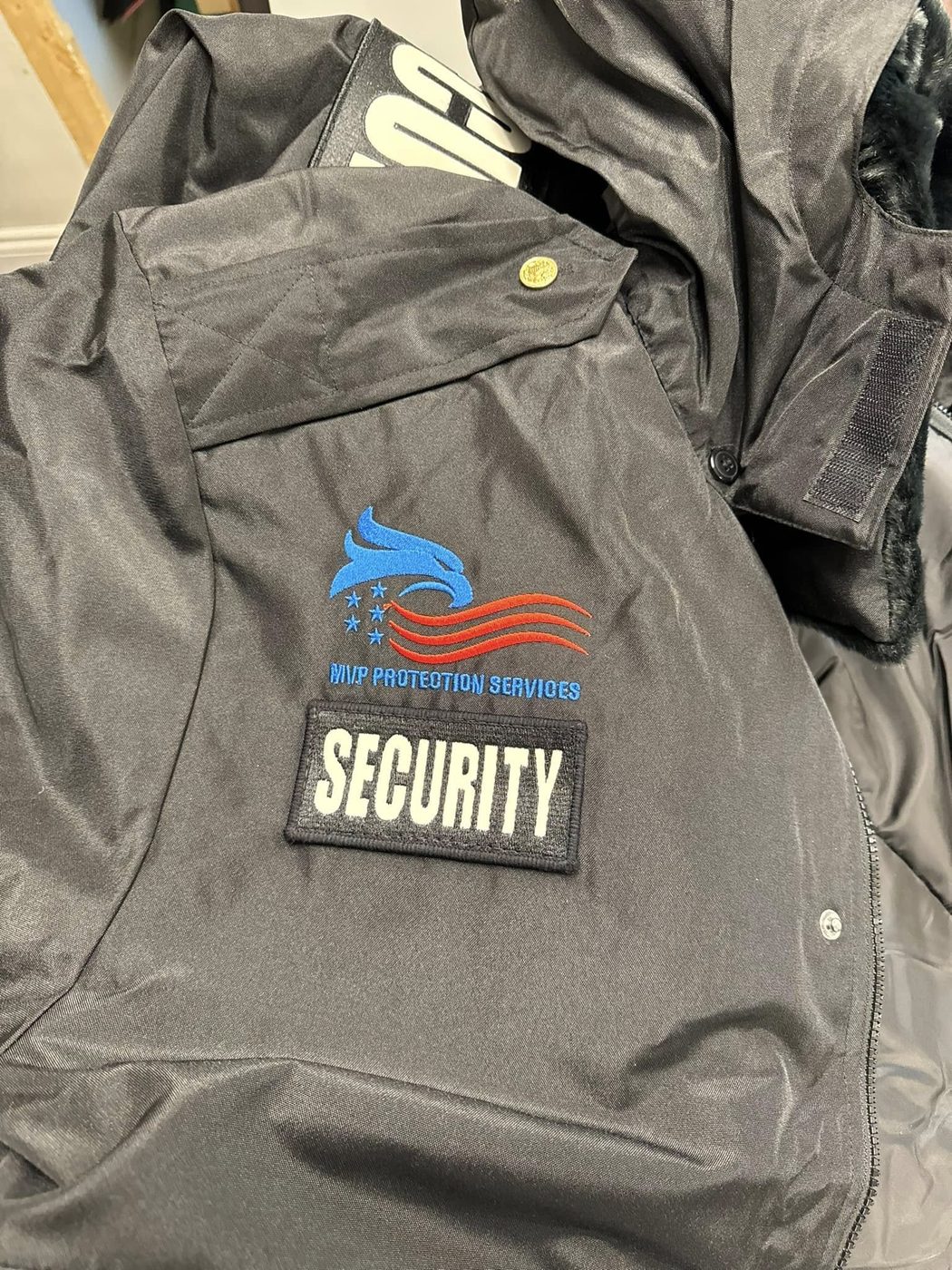 MVP Protection Services logo embroidered on a gray jacket
